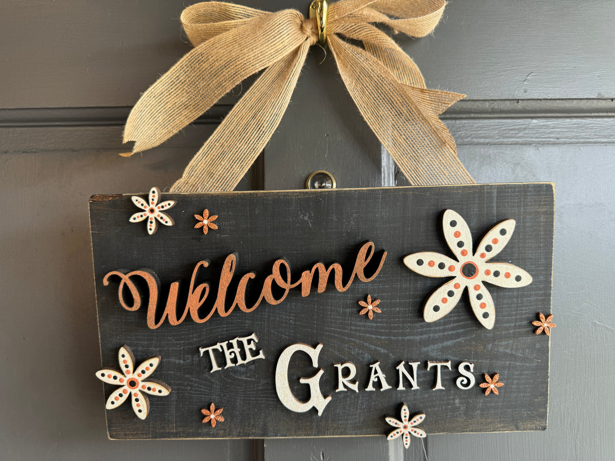 Rustic Wood Floral Family Name Sign in Orange and Black