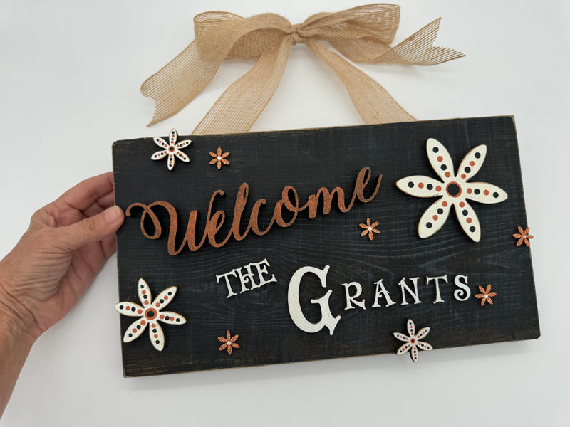 Rustic Wood Floral Family Name Sign in Orange and Black