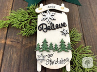 White Sled Christmas Ornament - Personalized Winter Scene with "Believe" & Pine Trees