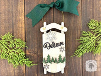 White Sled Christmas Ornament - Personalized Winter Scene with "Believe" & Pine Trees